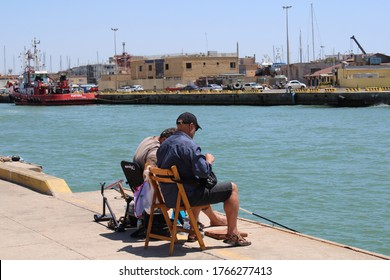 Old Couple Fishing At Fiumicino Coast Rome Italy Photo Date 29-06-2020 Fiumicino Rome Italy