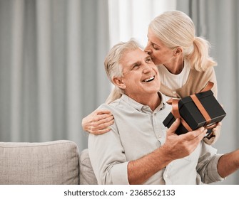 Old couple, gift and birthday, kiss with love and surprise, man and woman at home, celebration and care. Happiness, present for anniversary with smile for special event and marriage with partner - Powered by Shutterstock