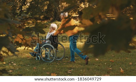 Similar – Granddaughter running to grandmother in wheelchair