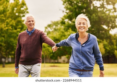 Old couple holding hands, outdoor in park and smile, happiness with freedom in nature, love and retirement. Happy, man and woman with travel, relationship with trust in marriage and commitment - Powered by Shutterstock