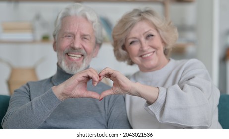 Old Couple Holding Hands Together In Heart Shape