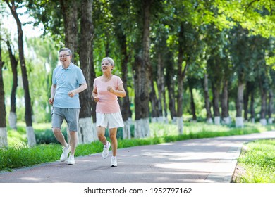 Old couple jogging in outdoor park smiling - Powered by Shutterstock