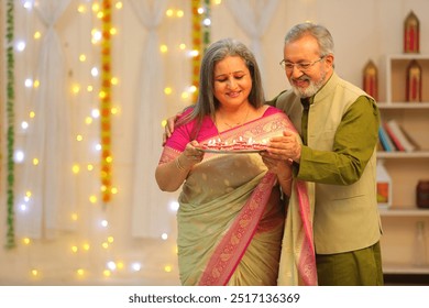 old couple looking into camera celebrate diwali - Powered by Shutterstock