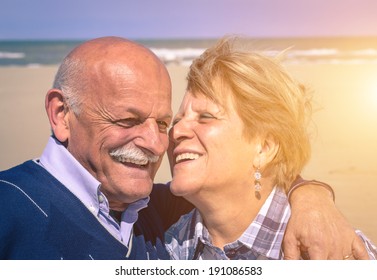 Old Couple In Love On The Beach