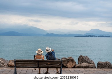 old couple on the pier at the lake Garda - Powered by Shutterstock