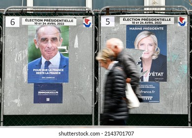 A Old Couple Of Pedestrians Passes Official Campaign Posters Of Eric Zemmour And Marine Le Pen On Electoral Billboards (sign). Before The Election, On April 5, 2022 In Paris, France.