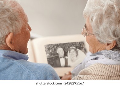 Old couple, photo album and memory nostalgia to remember wedding in retirement for connection, bonding or together. Elderly man, woman and photography book for union commitment, rear view or past