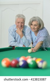 Old Couple Playing Billiard