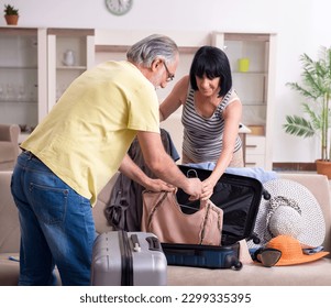 Old couple preparing for vacation travel - Powered by Shutterstock