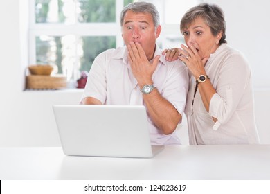 Old Couple Surprised In Front Of A Laptop Together