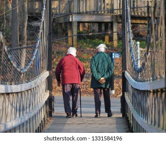 Old Couple Walking On Bridge