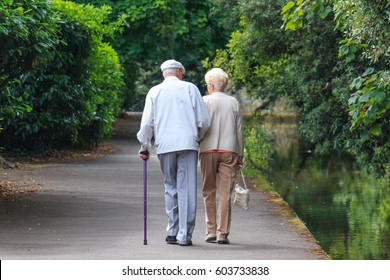  Old Couple Walking In The Park 