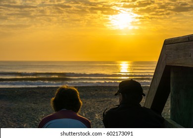 Old Couple Watching The Sunrise Together