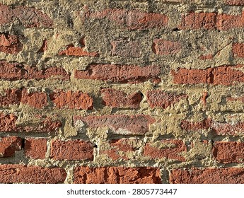 Old cracky bricks texture background in grazing light.