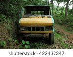 Old crashed pickup van in the forest.