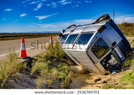 An old crashed van on the side of a road