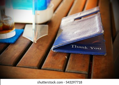 Old Credit Card And Receipt Holder Put On Restaurant Old Dining Table Background Scene. 