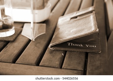 Old Credit Card And Receipt Holder Put On Restaurant Old Dining Table Background Scene. 