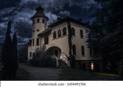 Old Creepy House With Spooky Details Dark Horror Atmosphere. Haunted House Scene With Many Crows And Black Cat Like In Halloween Movies. Frightful Manor With Strange Light In The Ghost Tour Journey