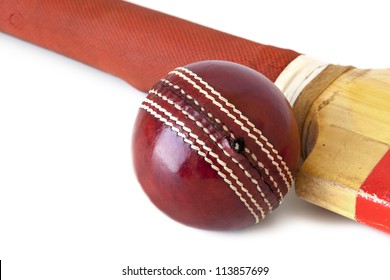 Old cricket bat and cricket ball, over white background.