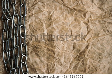 Old crumpled paper texture with metal chain 