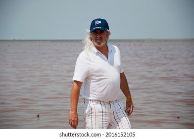 Old Cuban Man In Cap At Beach. Senior Grizzled Man With Long Gray Hair. Sos Cuba. Adult Male Cuban.