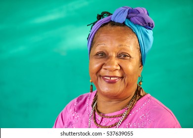 Old Cuban people and emotions, portrait of senior african american lady laughing and looking at camera. Happy elderly black woman from Havana, Cuba smiling