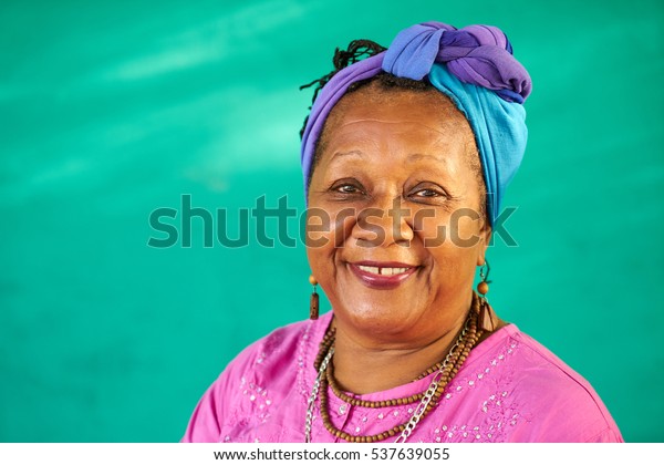 Old Cuban people and emotions,\
portrait of senior african american lady laughing and looking at\
camera. Happy elderly black woman from Havana, Cuba\
smiling