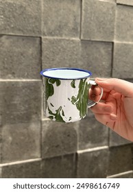 Its old cup from java indonesia. The theme of this cup made from zinc. It has green and white absctract pattern . Its famous in indonesia a long time ago