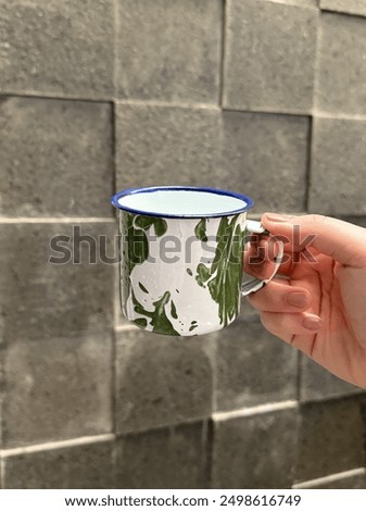 Its old cup from java indonesia. The theme of this cup made from zinc. It has green and white absctract pattern . Its famous in indonesia a long time ago