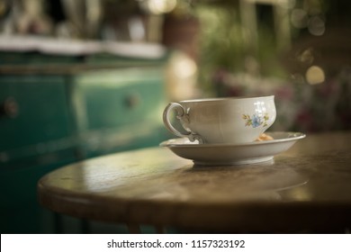 An old cup of tea on the table.