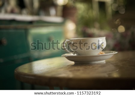 An old cup of tea on the table.