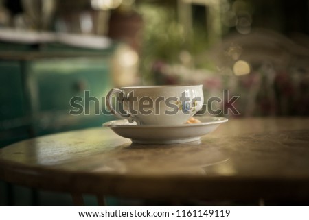 An old cup of tea on the table.