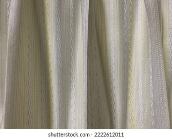 Old Curtains In Light Colors With Patterns In Them.