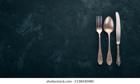 Old cutlery. On a black stone background. Top view. Free space for text. - Powered by Shutterstock