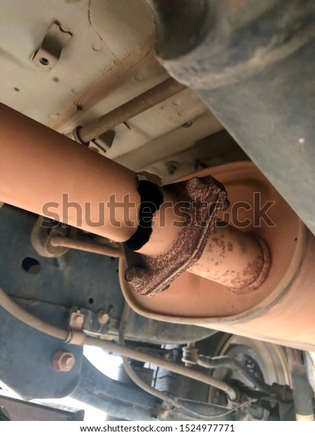Old Damaged\
car exhaust  Broken must be\
repaired