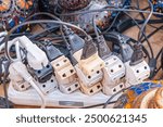 Old and damaged electric adapter power plug has many appliances are plugged outlet socket concept of risk danger overloaded current electrical. Overloaded power plugs, close up