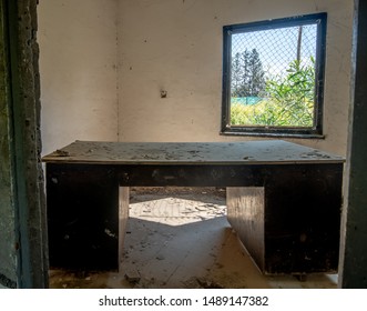 Old Damaged Wooden Desk In The Interior Of An Abandoned Office Room