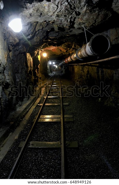 Old dark dangerous mine\
corridor