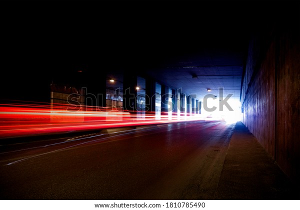 Old dark\
tunnel with colorful trails of\
light.