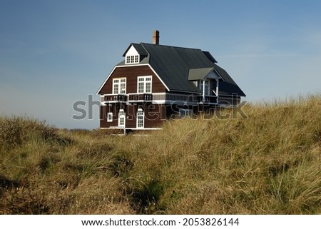 Old dark wood summerhouse in the dunes of Cape Grenen, meeting point of Skagerrak and Kattegat and the northernmost point of Denmark, Skagen, Northern Jutland, Denmark
