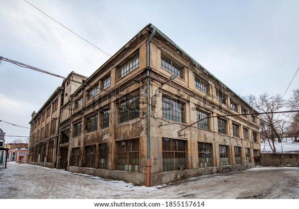 An old decayed industrial building in an\
industrial district
