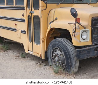 Old Decommissioned School Bus With A Flat Tire