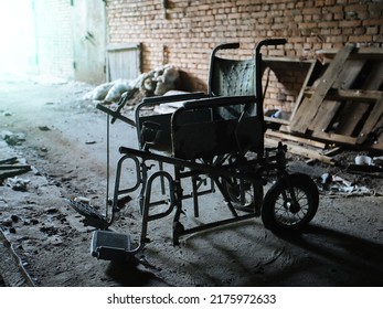 Old derelict wheelchair inside of the abandoned ruined hospital - Shutterstock ID 2175972633