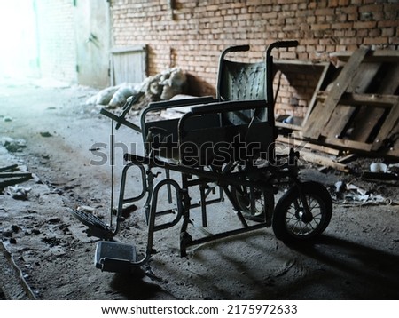 Old derelict wheelchair inside of the abandoned ruined hospital