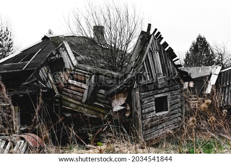 Old destroyed abandoned wooden house. Rustic broken building.