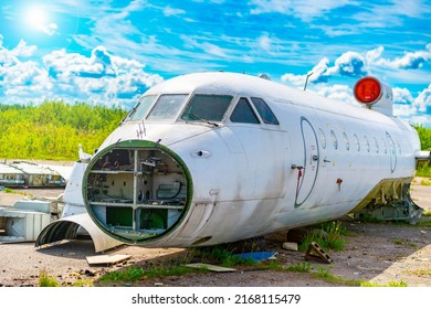Old destroyed dismantled and abandoned Soviet aircraft in the field. Aircraft graveyard. Aviation crisis.