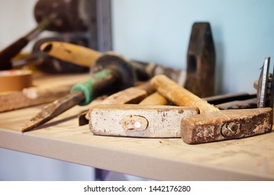 Old destroyed hammers among other hand tools