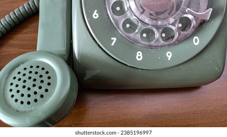 old dial up analog phone. home phone telephone in green color.