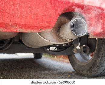 Old diesel car exhaust detail, with fumes. Now deemed environmentally unfriendly. Visible soot.